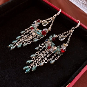Detail of vintage chandelier earrings with crystal fringes in a black velvet jewelry box