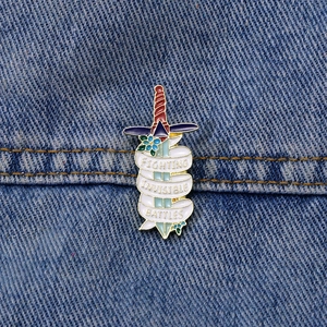 Cartoon sword brooch with Fighting Invisible Battles banner on blue denim fabric