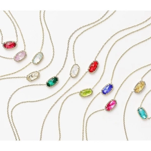 Gold-plated necklaces with colorful oval faceted natural stones on a white background