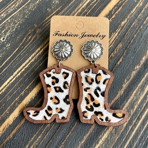 Detail of western cowboy boot earrings with leopard print inlay and wooden frame