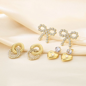 Three pairs of 18K gold plated bow and heart earrings with pearls and zircons