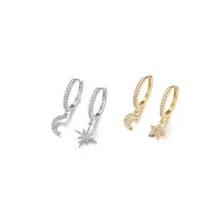 Detailed close-up of asymmetric star and moon hoop earrings in gold and silver plating