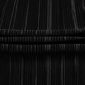 Detailed view of black pleated fabric texture with fine vertical ruffles and soft sheen