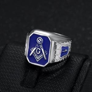 Men's silver steel Freemason ring with blue enamel and G compass logo on a black stand