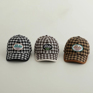 Close-up of three checkered wool baseball caps with oval embroidered logo patches