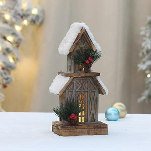 Lighted wooden Christmas house with snowy roof and warm LED lights for holiday decor