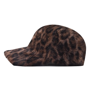 Close-up of soft leopard print faux fox fur texture on the winter baseball cap