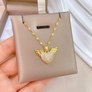 Luxury titanium heart necklace with crystal wings in a jewelry gift box