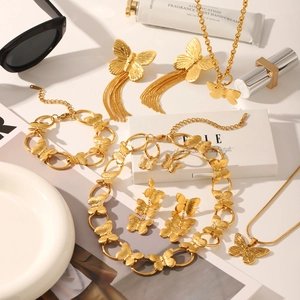 Golden butterfly jewelry set featuring necklaces, earrings, and bracelet with fine texture