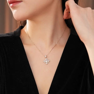 Close-up of elegant gold flower necklace with zircon petals worn by a female model