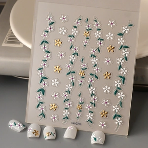 Detailed 5D embossed floral nail stickers with white flowers and golden metallic accents