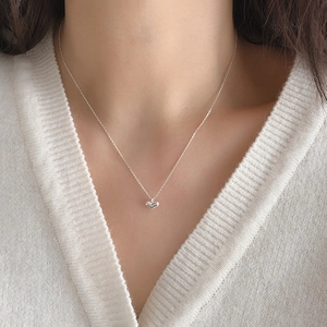 Elegant 925 sterling silver heart pendant necklace shown on a model's collarbone