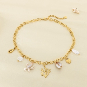 Detail of 18K gold-plated ocean theme necklace with starfish and seashell charms