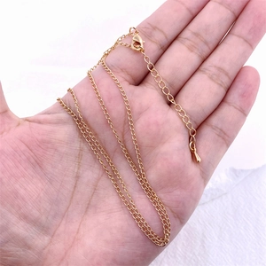 Close-up of golden O-chain necklace featuring an adjustable extension and lobster clasp