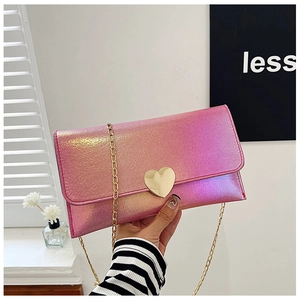 Detail of pink gradient metallic purse with heart-shaped gold buckle and chain