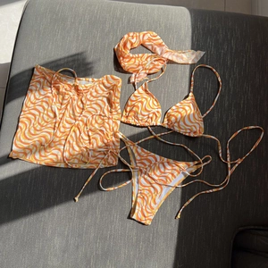 Detail of 4-piece bikini set with orange marble print and matching headscarf