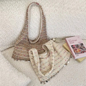 Detail of colorful sequins and shell fringe on boho knit tote bags over soft fleece