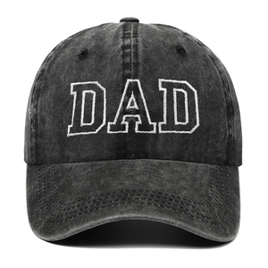 Detailed view of dark gray washed cotton dad hat featuring white DAD embroidery