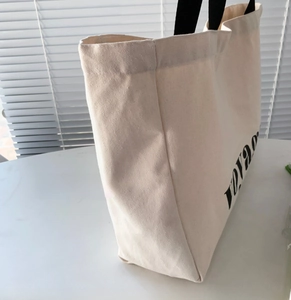 Detail view of the wide three-dimensional bottom on this canvas tote travel bag