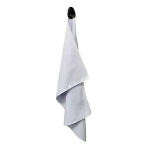 Macro shot of white waffle weave microfiber golf towel with a black hanging hook