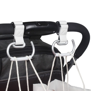 Detail of white leather stroller hook with silver metal ring on handle