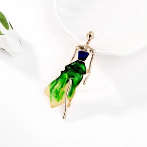 Close-up of elegant dancing girl brooch with colorful enamel details and gold plating