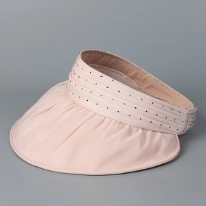 Detail of light pink organza sun hat with black polka dots and pleated wide brim style