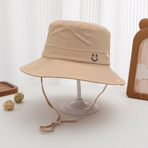 Detail of light khaki sun hat with smiley embroidery and adjustable chin strap