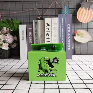 Close-up of a green robotic dinosaur money box on a checkered table with monster print