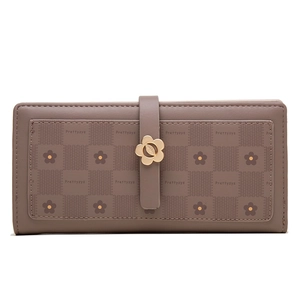 Close-up of metal flower clasp and checkered print on long women's faux leather wallet