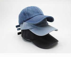 Three denim baseball caps in dark blue, light blue, and black showing stitching detail
