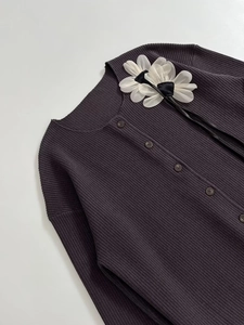 Detail of rib-knit cardigan with 3D sheer flower appliques and button-down front