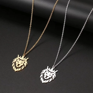 Detailed close-up of hollow lion head pendants in gold and silver finish with crown motifs