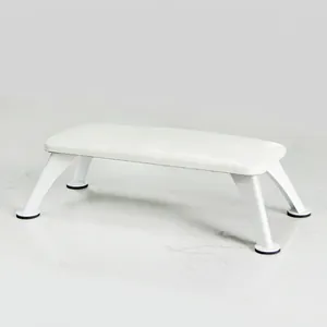 Detailed view of nail armrest cushion with white PU leather and sturdy metal legs
