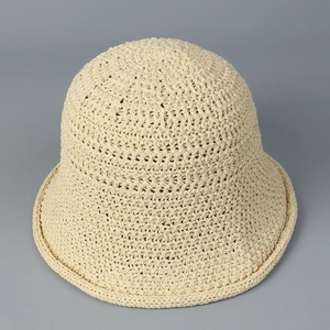 Macro shot of minimalist crochet bucket hat showing detailed cream woven pattern
