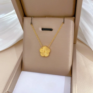 Minimalist titanium steel gold necklace with a five-leaf flower pendant in a jewelry box