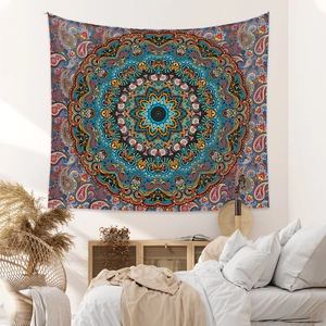 Detail of blue mandala tapestry with paisley patterns in a cozy bedroom setting