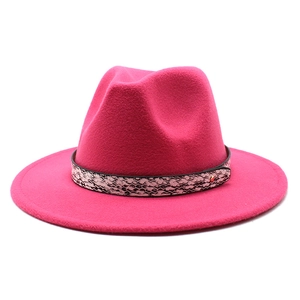 Detail of rose pink fedora hat featuring snake skin pattern band and golden rivet
