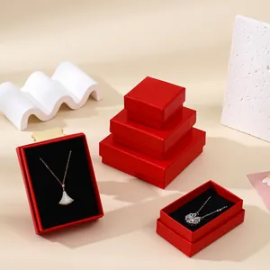 Detail of red Linen-patterned jewelry boxes with black velvet lining for necklaces