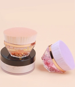 Detail of magic foundation brushes with liquid glitter flowing sand handles and soft bristles