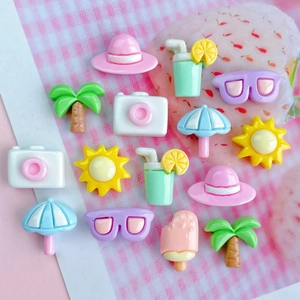 Colorful summer themed resin charms including palm trees and sun hats for DIY crafts