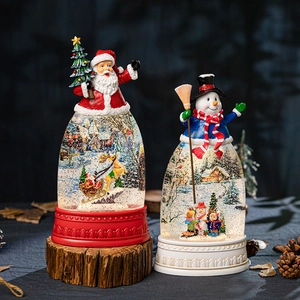 Christmas musical snow globe set with Santa and snowman on a rustic wooden base