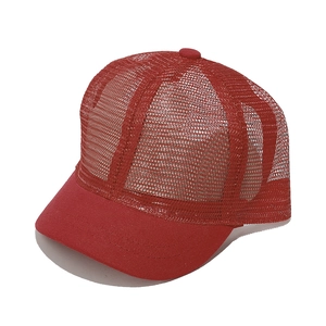 Close-up of a red breathable mesh trucker hat with short brim and cotton canvas front panels