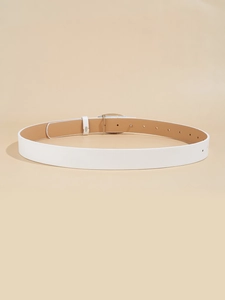 Detail of white leather belt showing silver heart buckle and adjustable holes for women