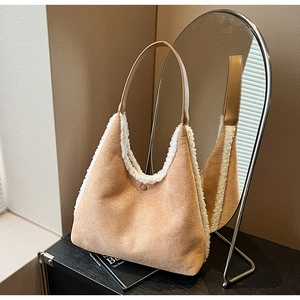 Detailed view of camel suede tote bag with white faux fur trim and snap button closure