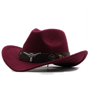 Close-up of wine red felt cowboy hat with leather band and silver bull head detail