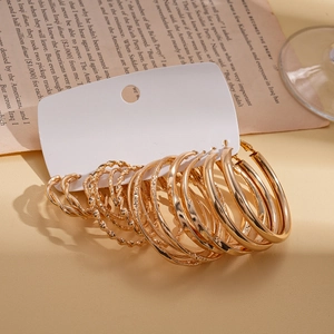 Set of 16 gold geometric hoop earrings with twisted and smooth designs on white card