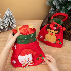 Christmas gift bags with snowman and reindeer designs in red and green holiday colors