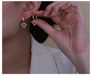 Macro shot of copper zircon heart earrings showing pavé setting and gold-plated finish