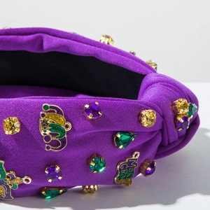 Detail of purple Mardi Gras headband featuring colorful rhinestones and metal charms